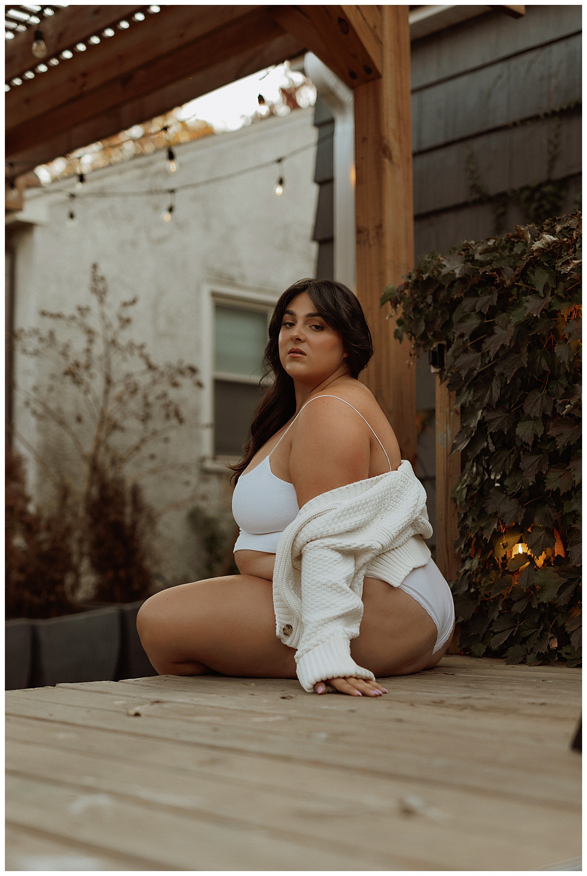 Woman sits on the edge of the steps for Minneapolis Boudoir Photographer