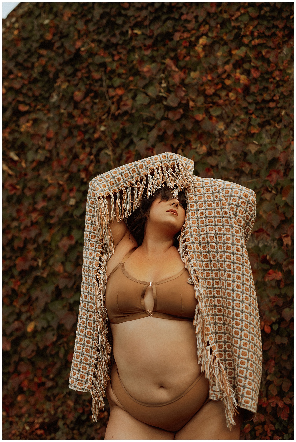 Female holds blanket around her body while modeling for Black Friday Sales for boudoir photographer