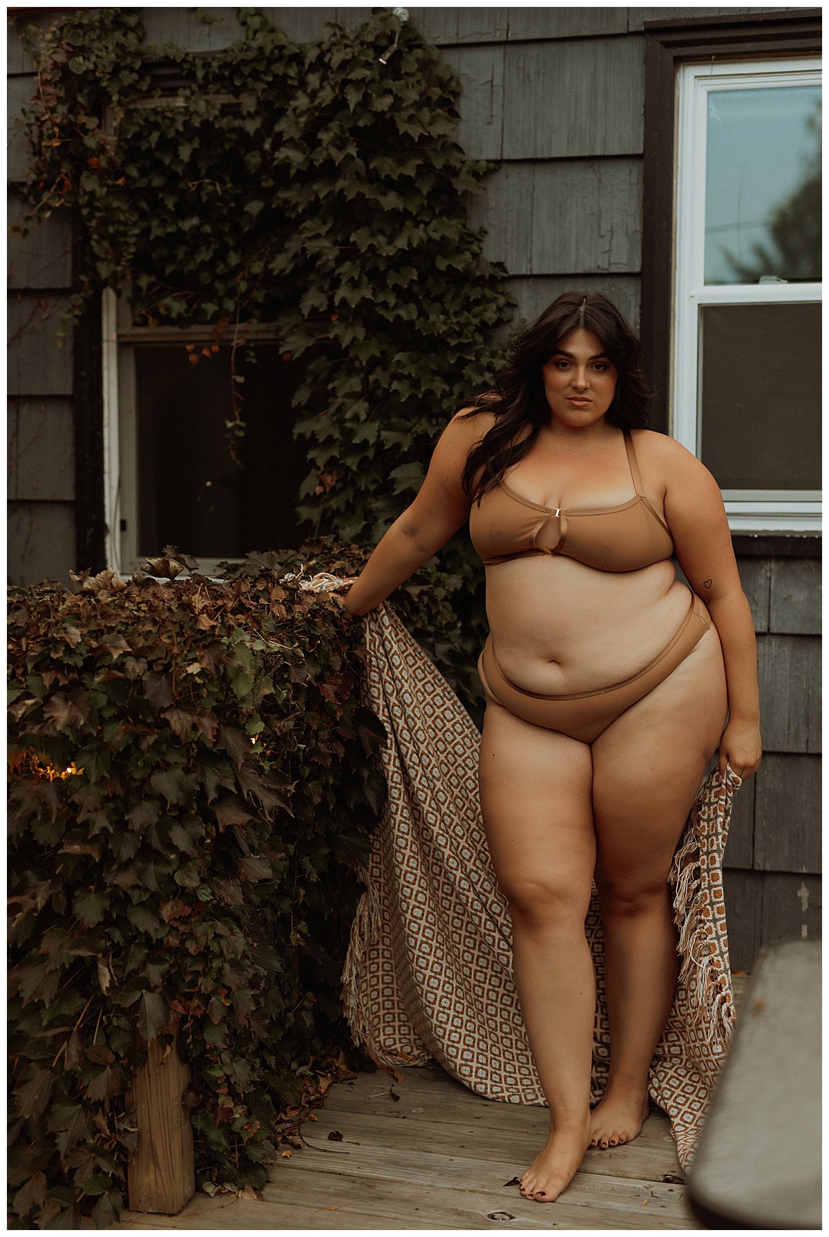 female stands tall wearing a brown lingerie set for Mary Castillo Photography