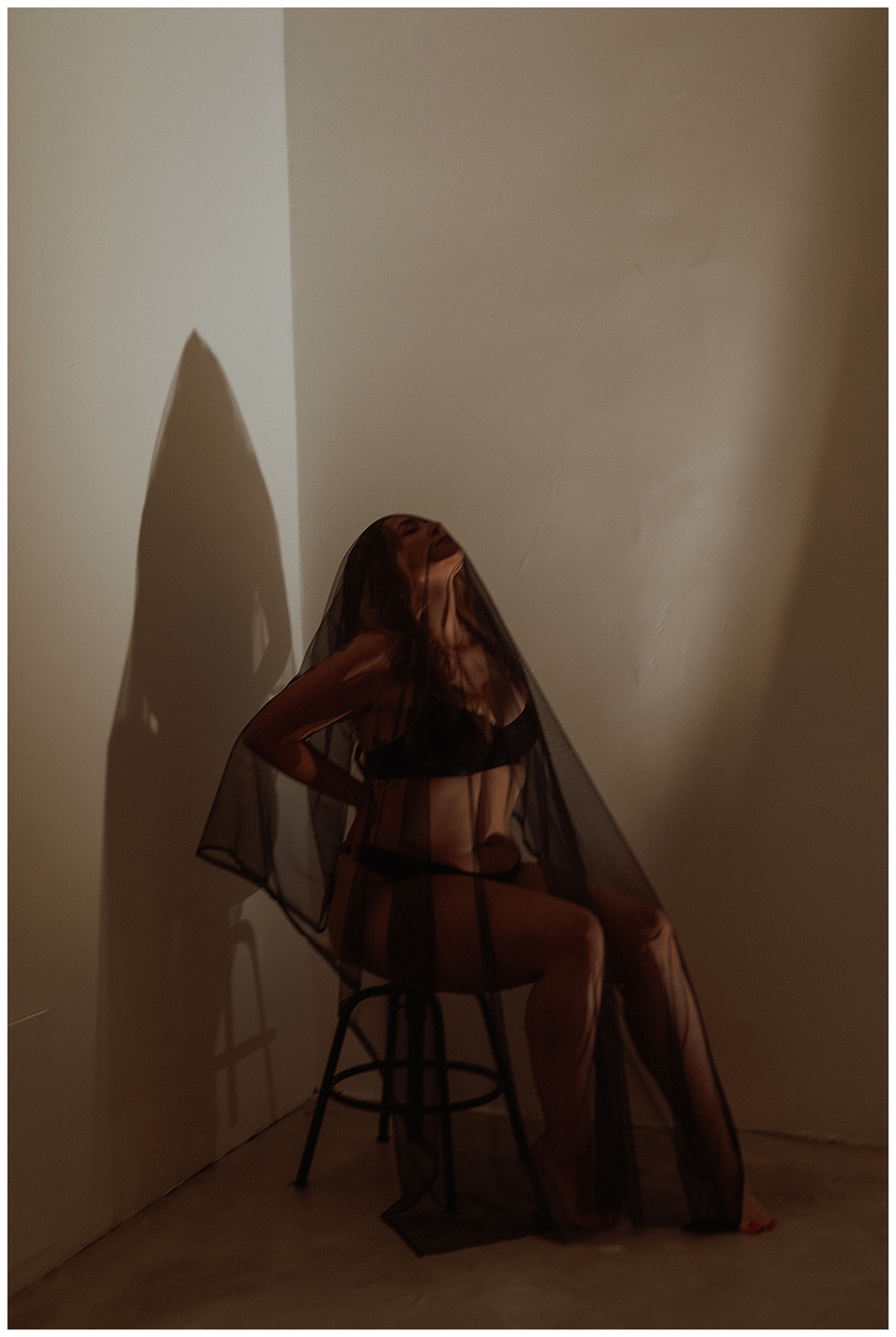 Woman covers herself with black veil for Minneapolis Boudoir Photographer