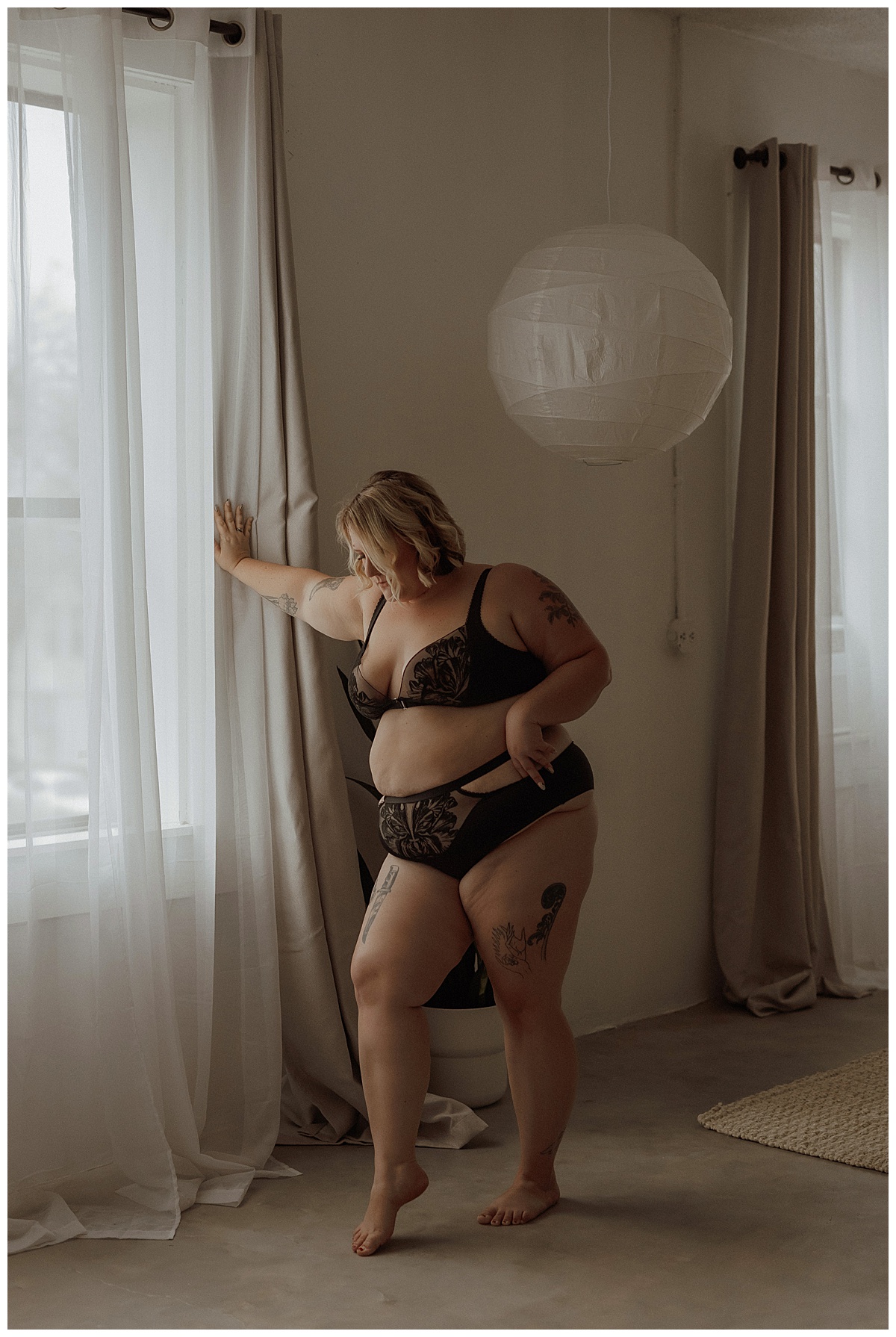 Person stands tall wearing black lingerie for Minneapolis Boudoir Photographer