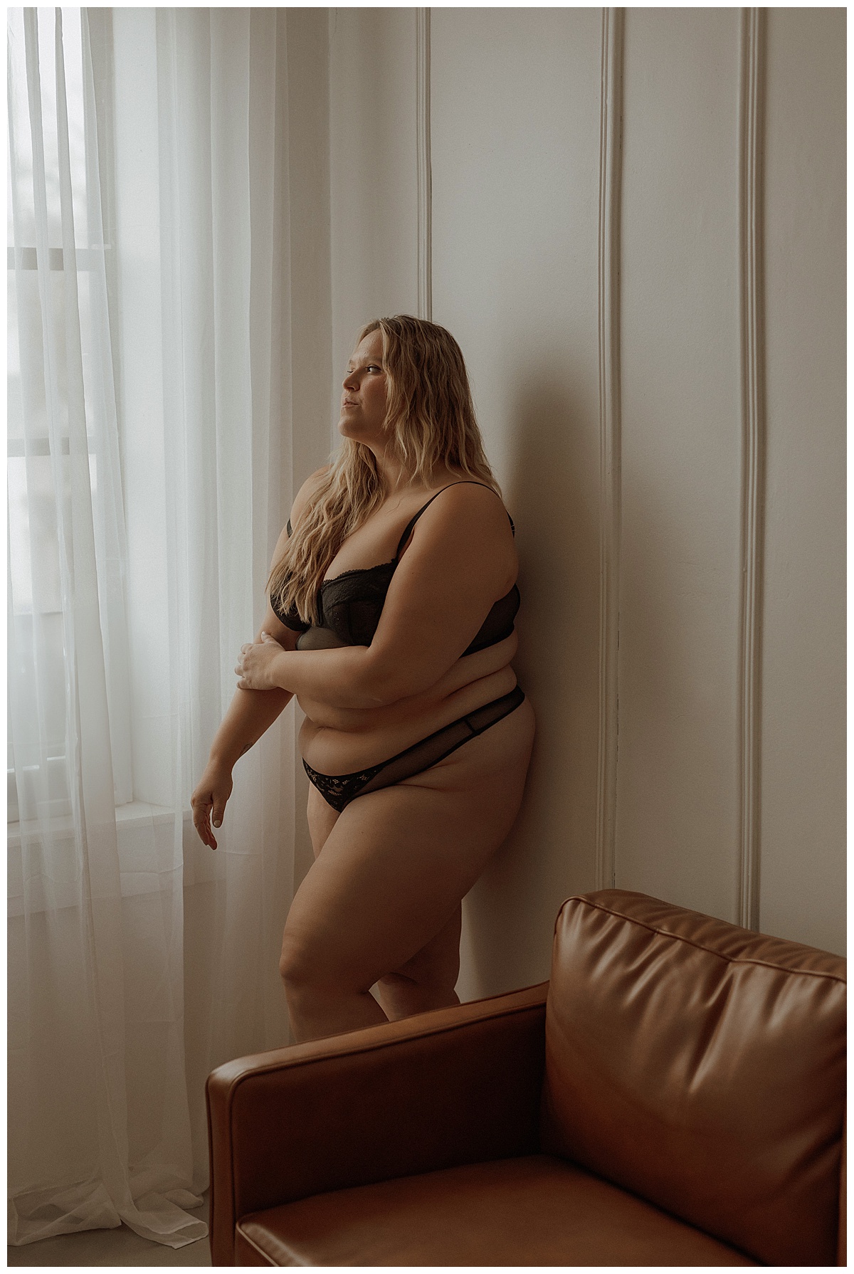 Woman wears black lingerie set showing why You Deserve This boudoir session