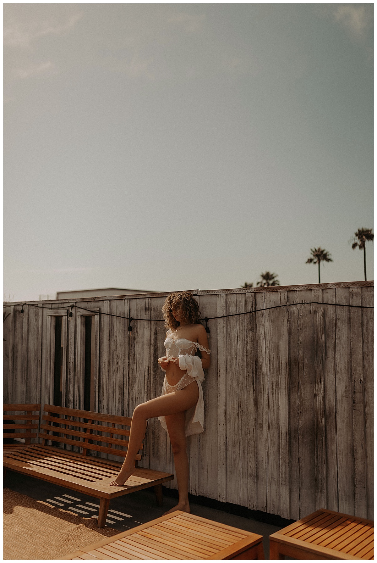 PErson stands tall wearing white lingerie for Minneapolis Boudoir Photographer