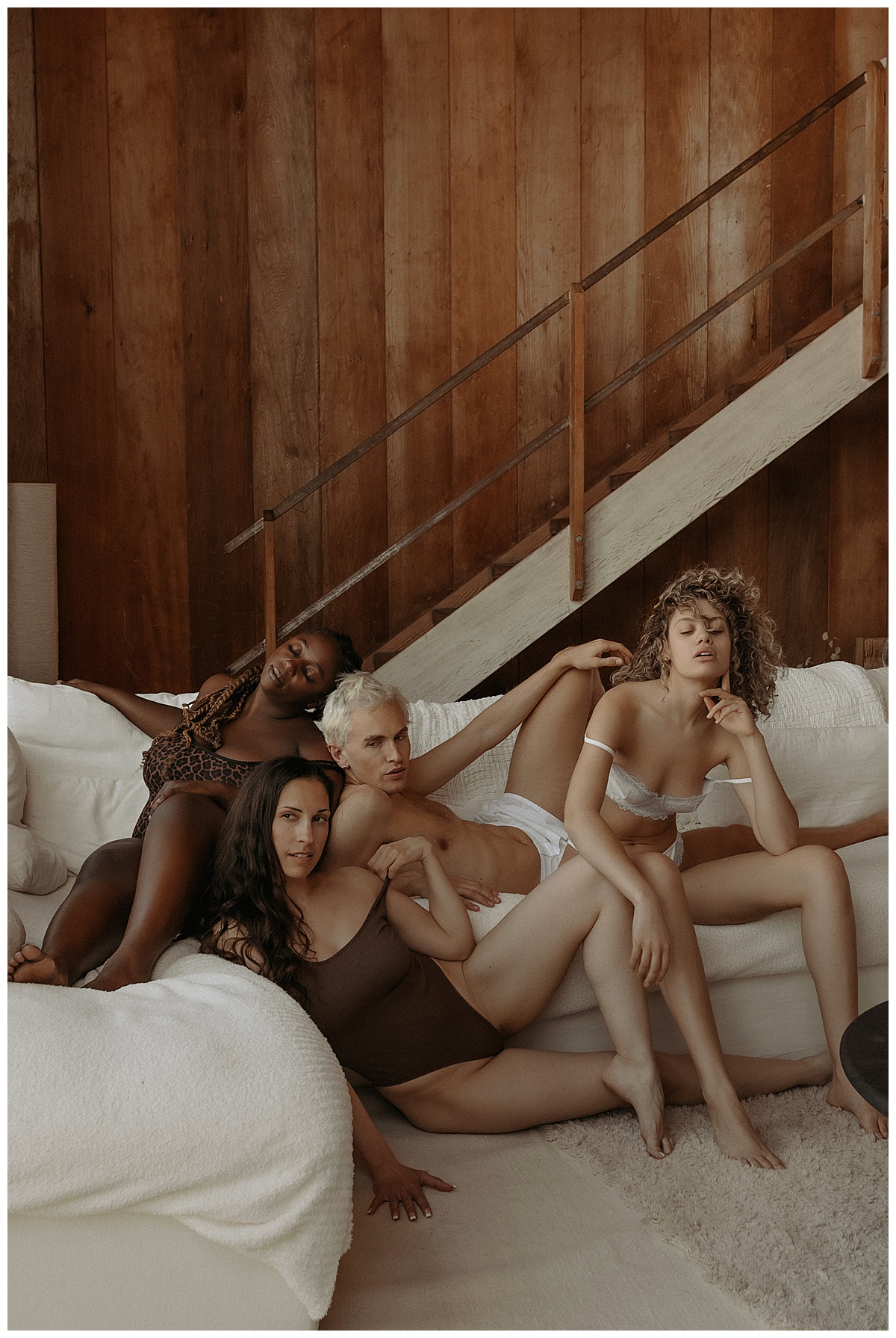 People sit together on a couch wearing lingerie for Mary Castillo Photography