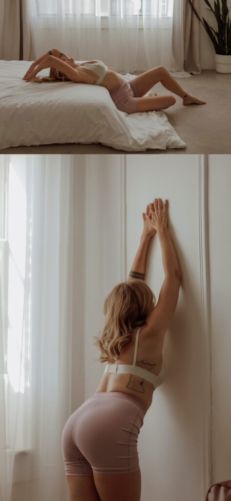 Client sits on the floor arching her back onto the bed with Minneapolis Boudoir Photographer