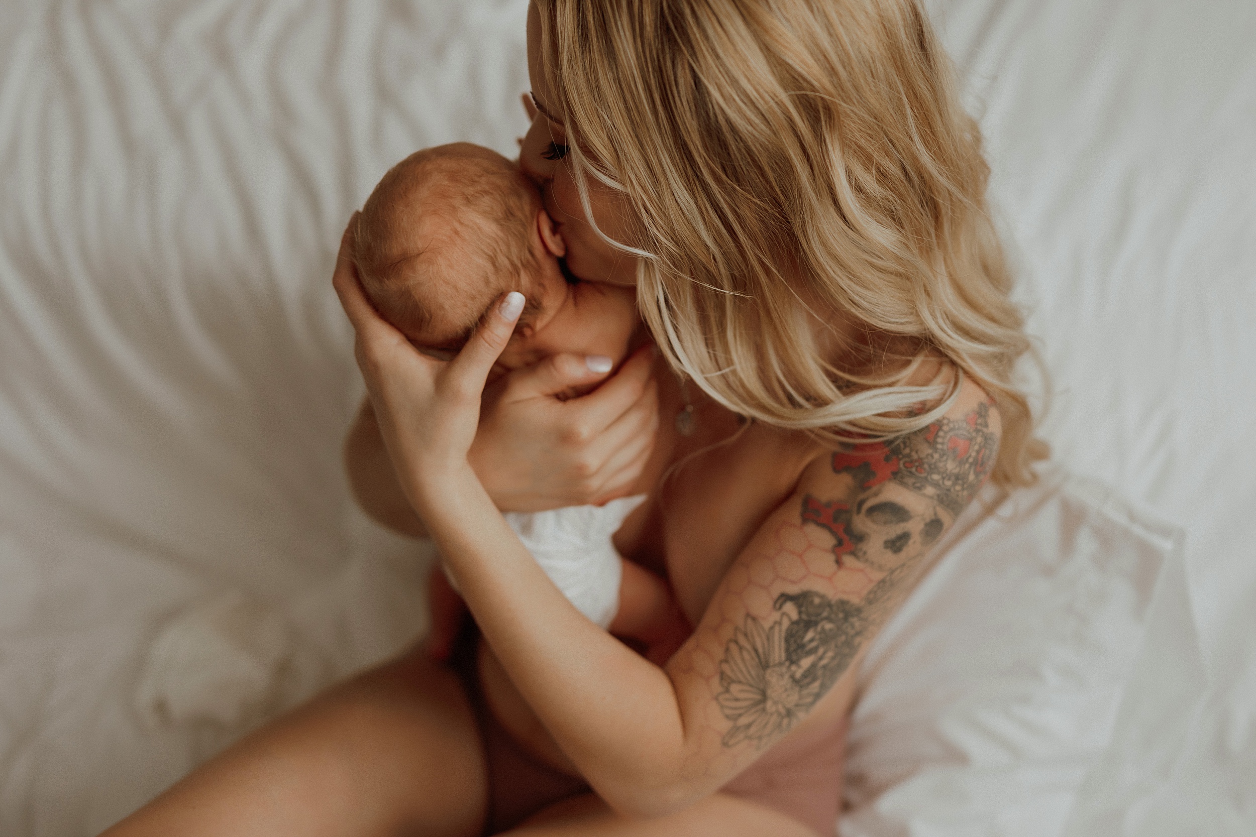 Closeup of mom kissing baby's ear in session with Mary Castillo Photography