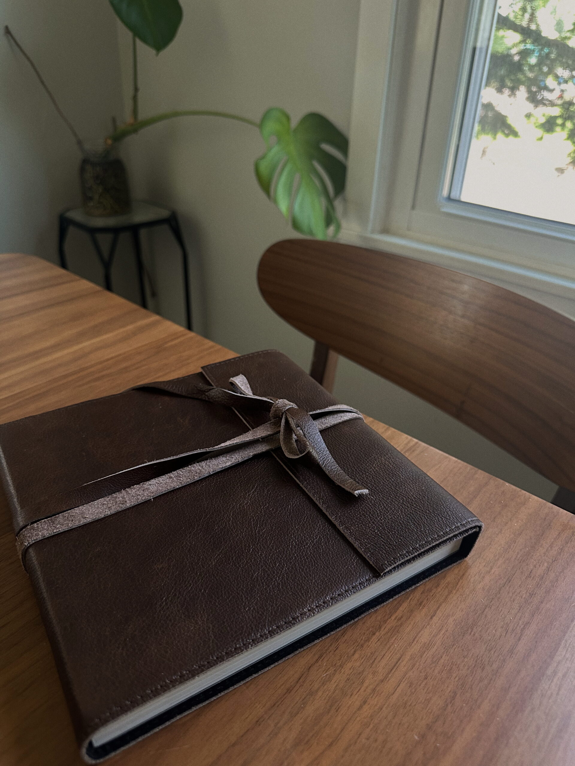 Soft leather album displayed on table for #1 Product Brides Choose blog